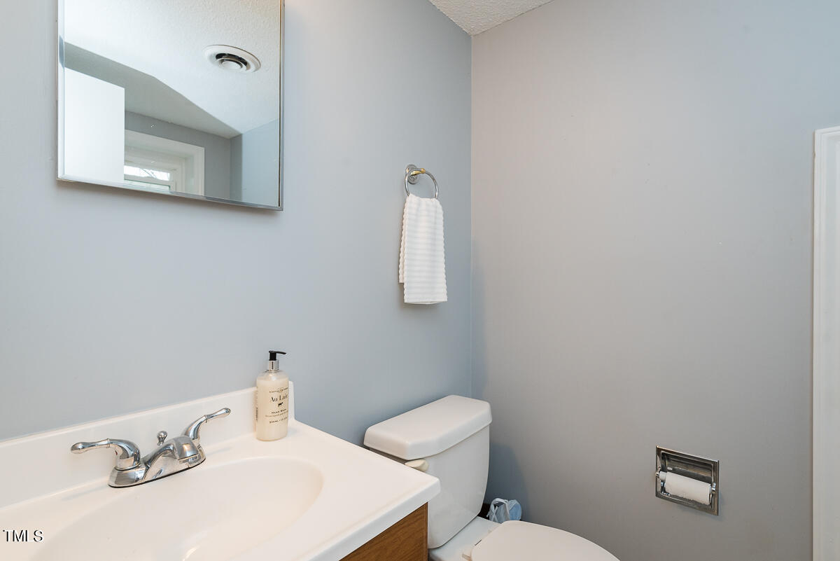 1026 Jerome Road Durham, NC 27713 - Photo 19 of 27 a bathroom with a toilet sink and mirror