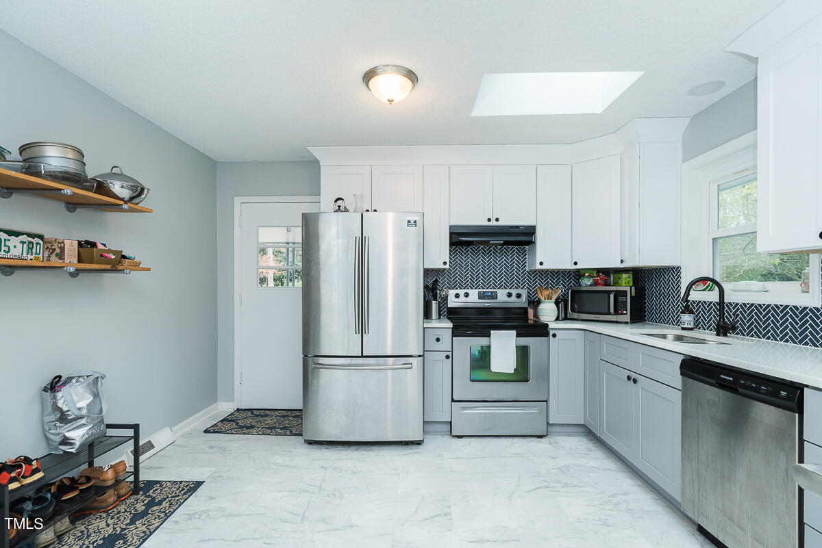 1026 Jerome Road Durham, NC 27713 - Photo 2 of 27 a kitchen with a refrigerator sink and cabinets