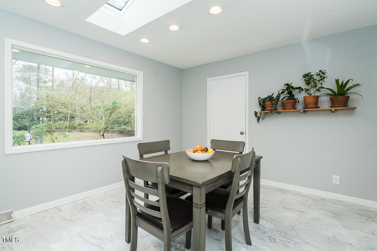 1026 Jerome Road Durham, NC 27713 - Photo 4 of 27 a view of a dining room with furniture window and outside view