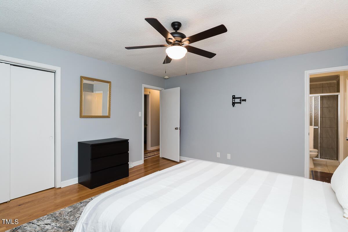 1026 Jerome Road Durham, NC 27713 - Photo 8 of 27 a bedroom with a bed and a ceiling fan