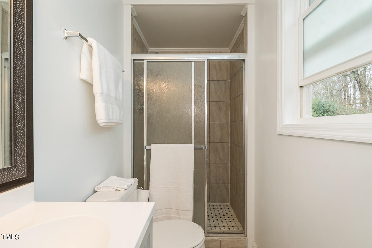 1026 Jerome Road Durham, NC 27713 - Photo 9 of 27 a bathroom with a shower and a toilet