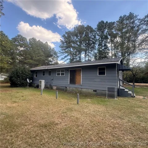 a backyard of a house with barbeque oven