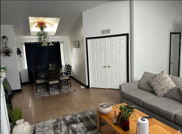 265 Mindella Way Layton, UT 84041 - Photo 7 of 32 Open-concept living space featuring vaulted ceilings and tile flooring