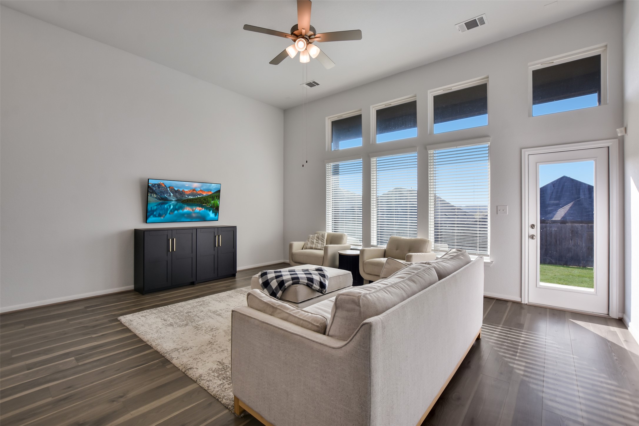 605 Oleander Loop Buda, TX 78610 - Photo 12 of 32 a living room with furniture and a floor to ceiling window