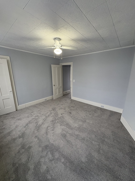 5 Prospect Street, Unit 2 Newburyport, MA 01950 - Photo 5 of 6 a view of an empty room with a chandelier fan
