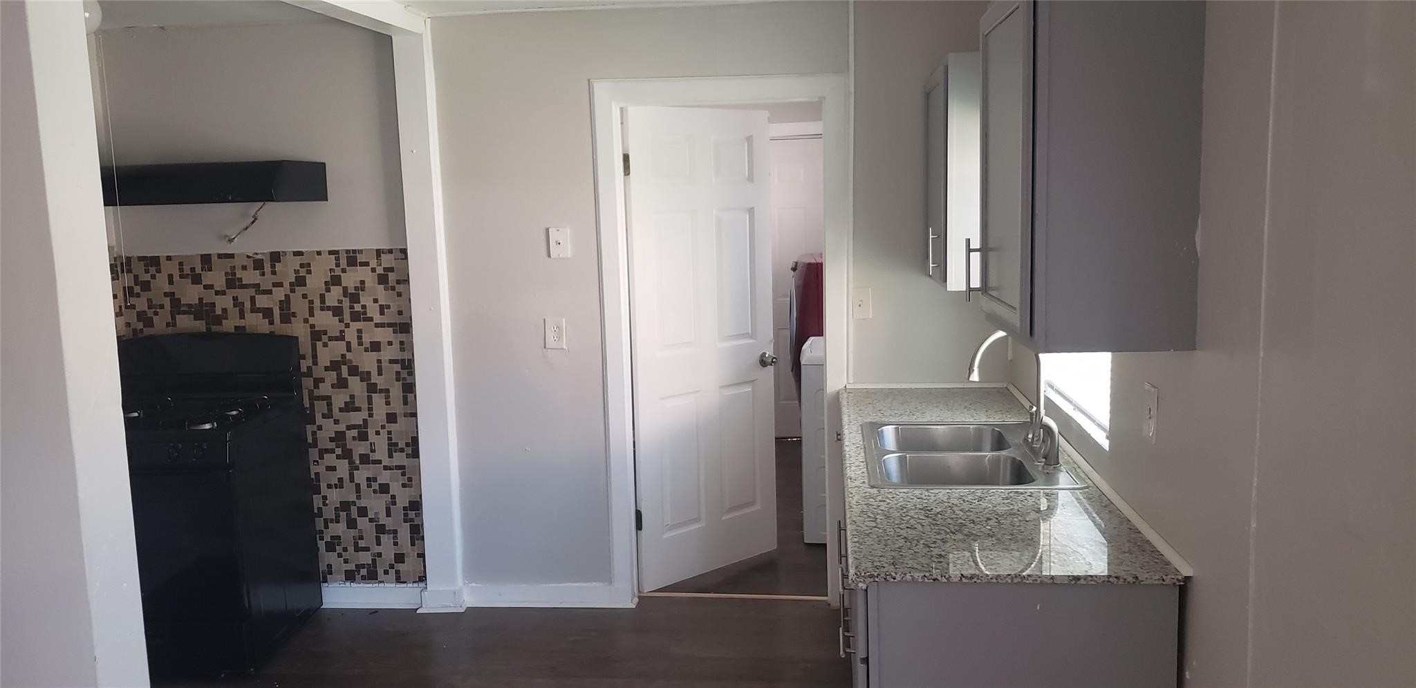 912 Jennetta Street Rosenberg, TX 77471 - Photo 2 of 12 a en suite bathroom with a granite countertop sink and a mirror
