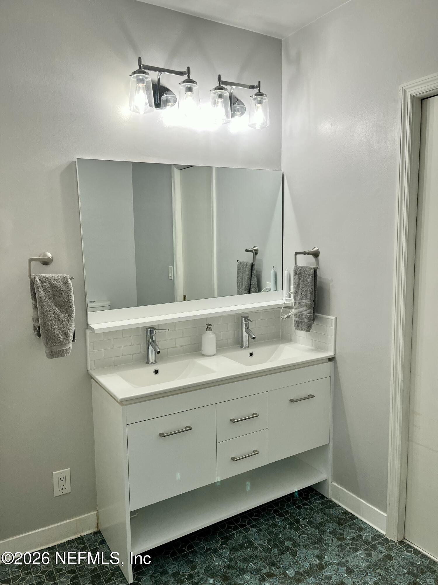 820 Inwood Terrace Jacksonville, FL 32207 - Photo 18 of 31 a bathroom with a double vanity sink and a mirror