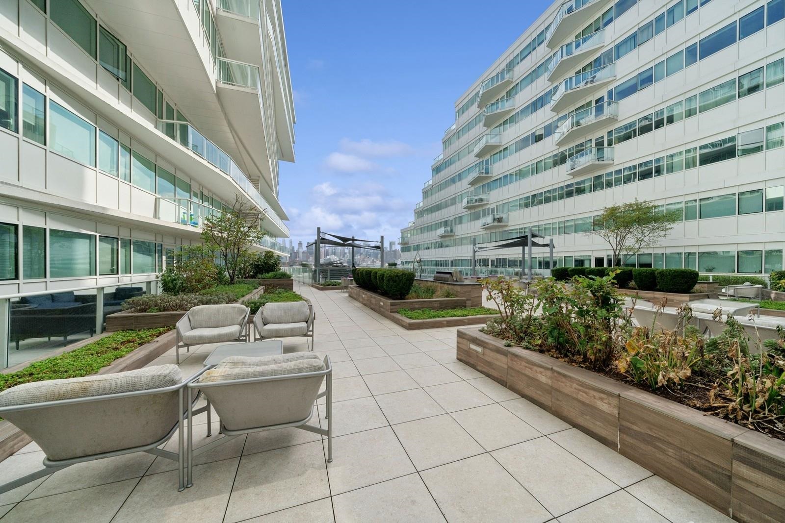 800 Ave At Port Imperial, Unit 309 Weehawken, NJ 07086 - Photo 1 of 15 a view of a patio with couches and potted plants