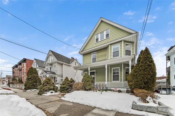 a sidewalk with a covered with snow in front of house