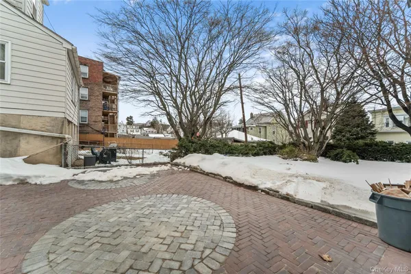 a view of white house with a yard covered in snow