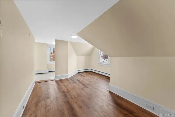a view of an empty room and wooden floor