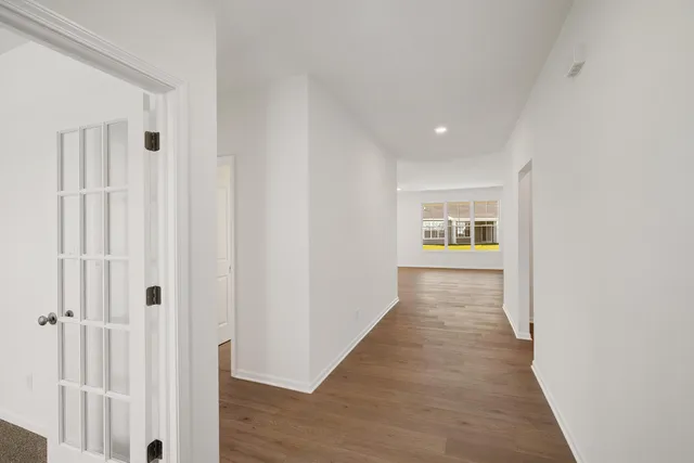 a view of a hallway with wooden floor