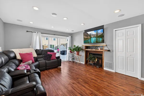 a living room with furniture a fireplace and a flat screen tv