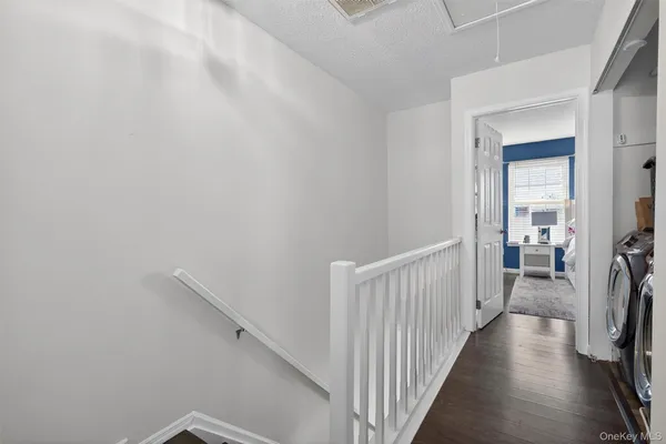a view of a hallway to a livingroom with furniture and storage