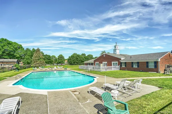 a view of a swimming pool with an outdoor space and seating area