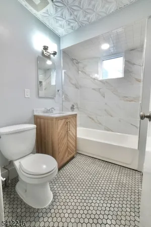 a bathroom with a toilet a sink and bathtub