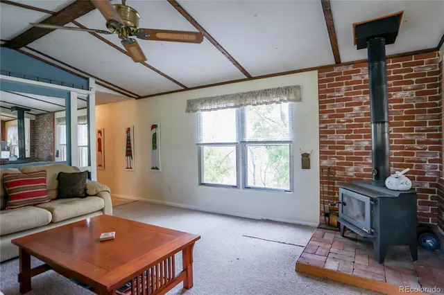a living room with furniture a rug and a window