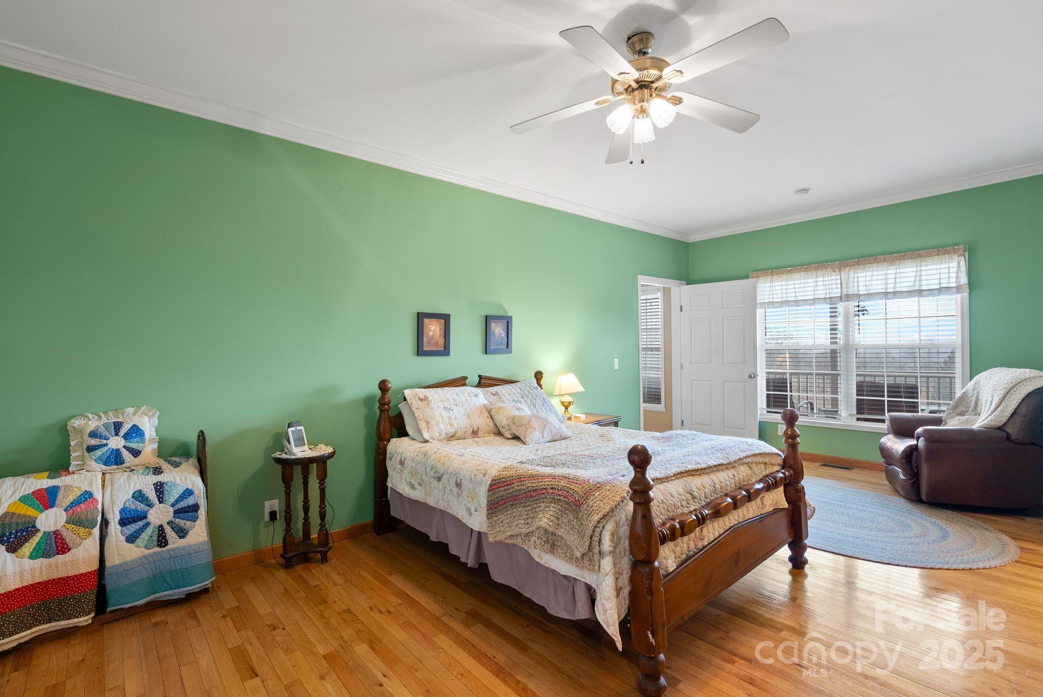 75 Pine Tree Drive Candler, NC 28715 - Photo 11 of 21 a bedroom with a bed and a chandelier