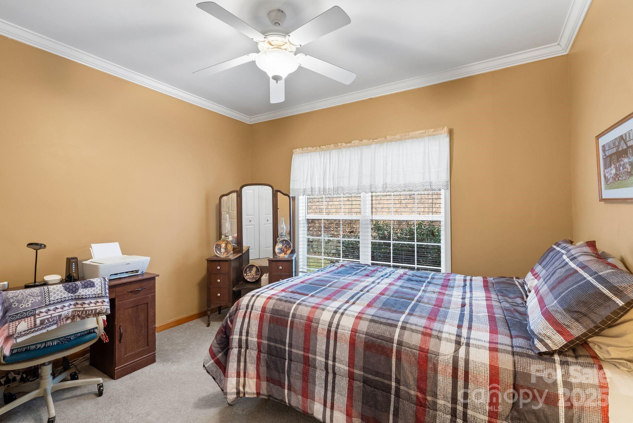 75 Pine Tree Drive Candler, NC 28715 - Photo 14 of 21 a bedroom with a bed and a chandelier