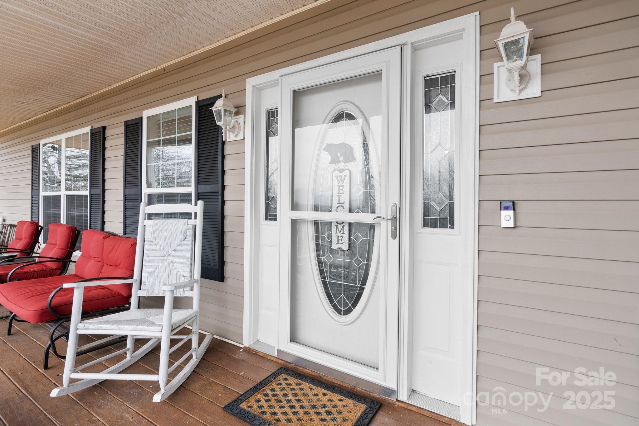 75 Pine Tree Drive Candler, NC 28715 - Photo 4 of 21 a porch with a chair and a table in a balcony
