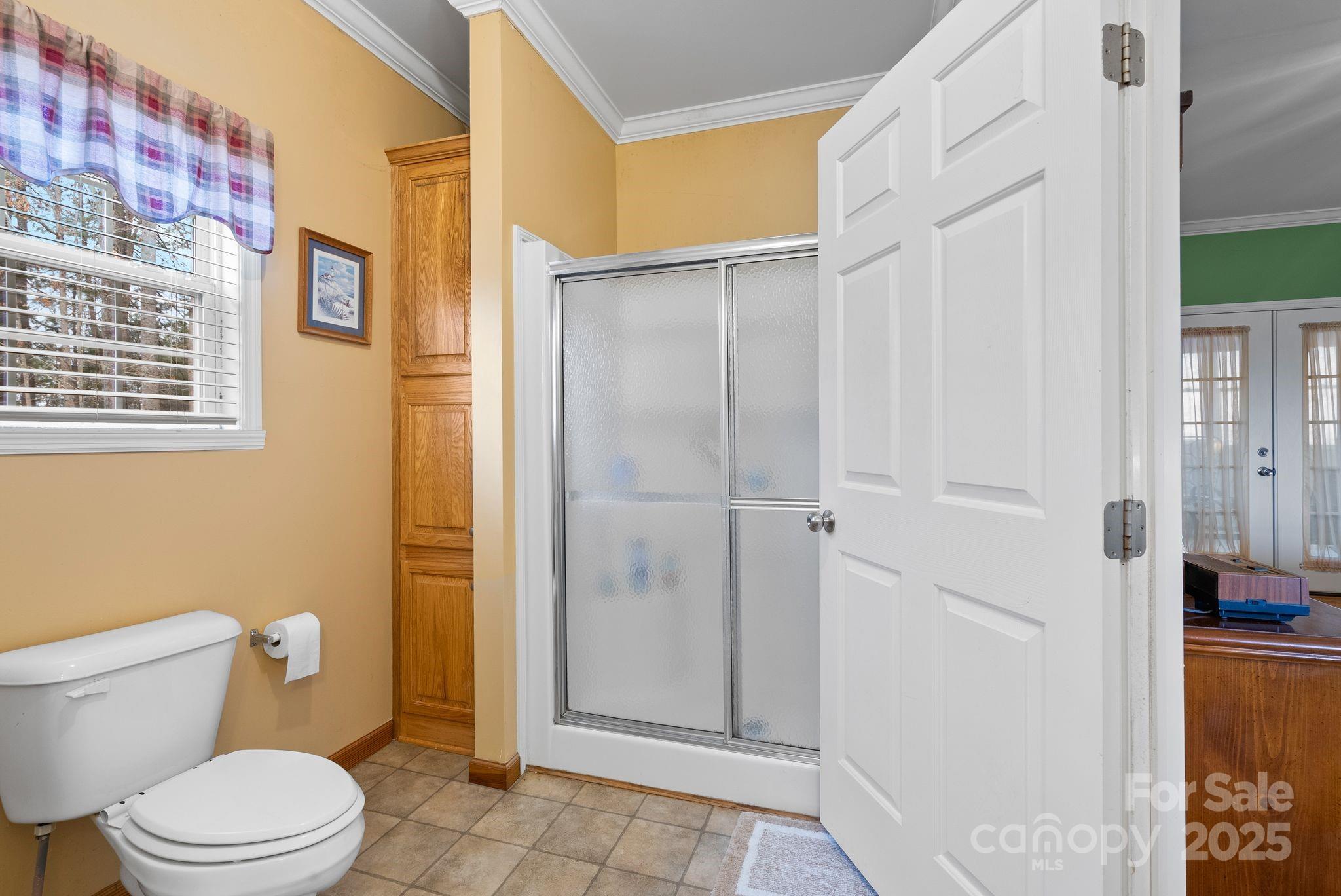 75 Pine Tree Drive Candler, NC 28715 - Photo 8 of 21 a white toilet sitting next to a bathroom sink