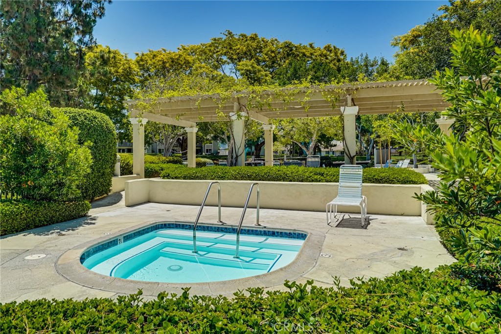 49 East Yale Loop, Unit 26 Irvine, CA 92604 - Photo 62 of 63 a view of a swimming pool with a patio