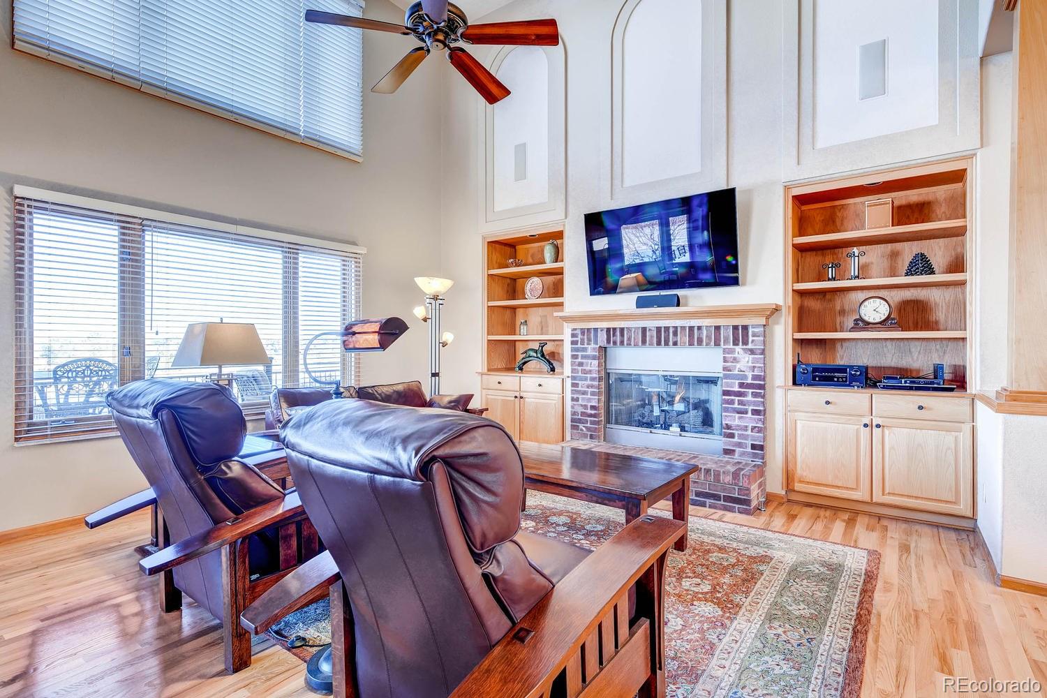 9470 Kemper Drive Lone Tree, CO 80124 - Photo 11 of 35 a living room with furniture a flat screen tv and a fireplace