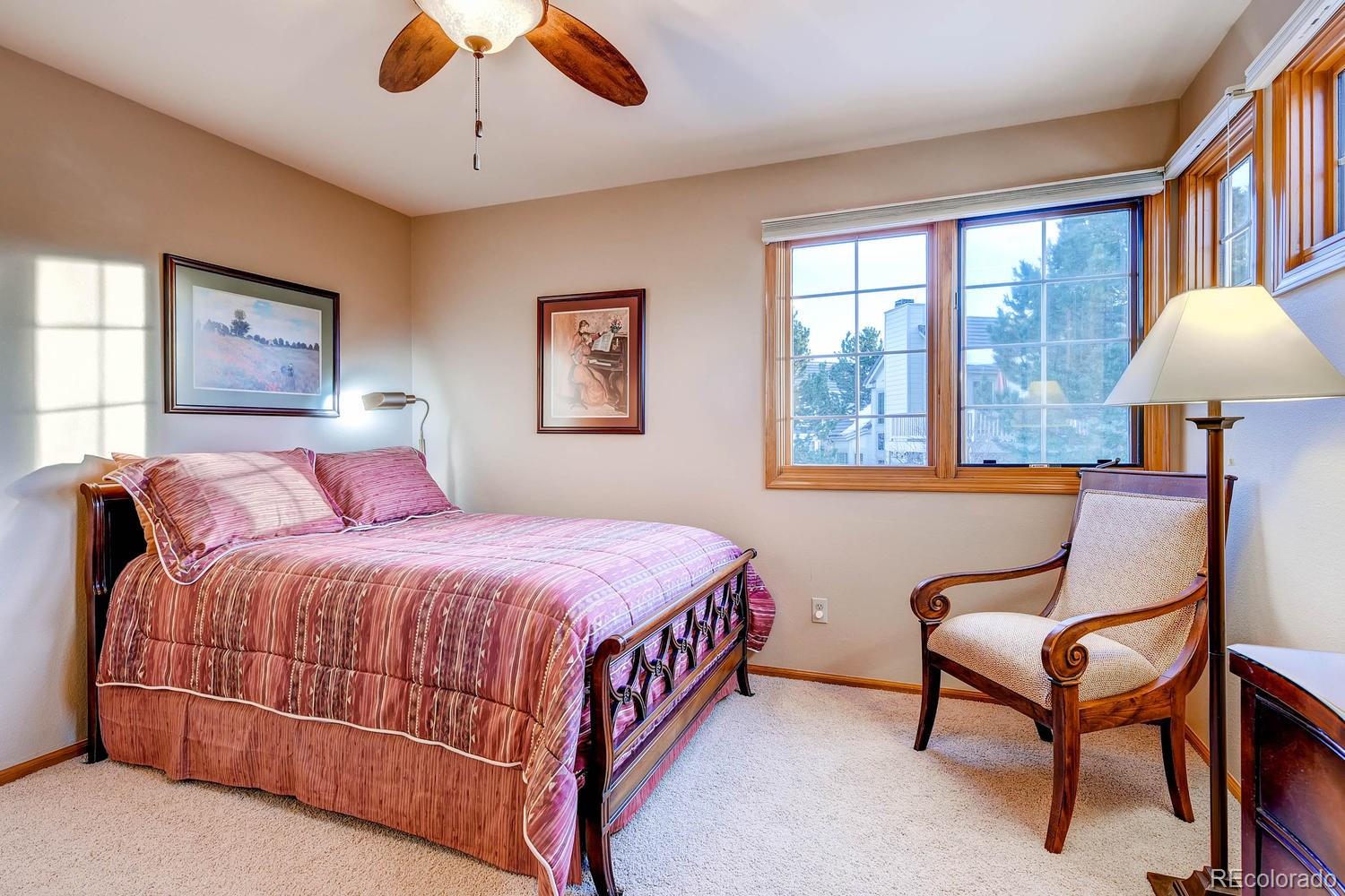 9470 Kemper Drive Lone Tree, CO 80124 - Photo 22 of 35 a bedroom with a bed chair and a window