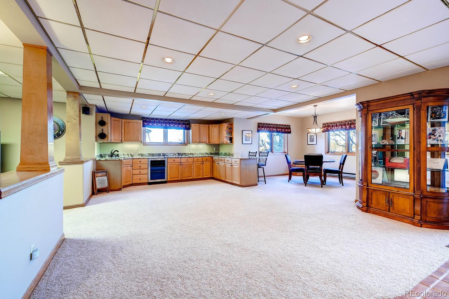 9470 Kemper Drive Lone Tree, CO 80124 - Photo 25 of 35 a large room with furniture and a kitchen