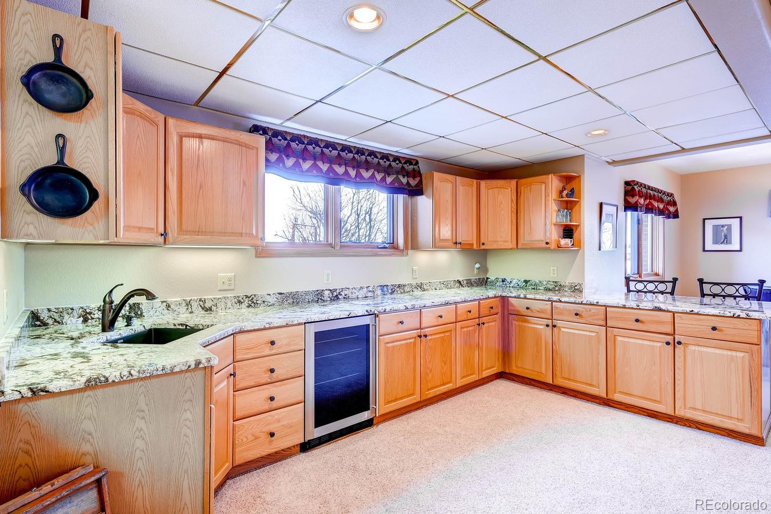 9470 Kemper Drive Lone Tree, CO 80124 - Photo 26 of 35 a kitchen with stainless steel appliances granite countertop a sink and cabinets
