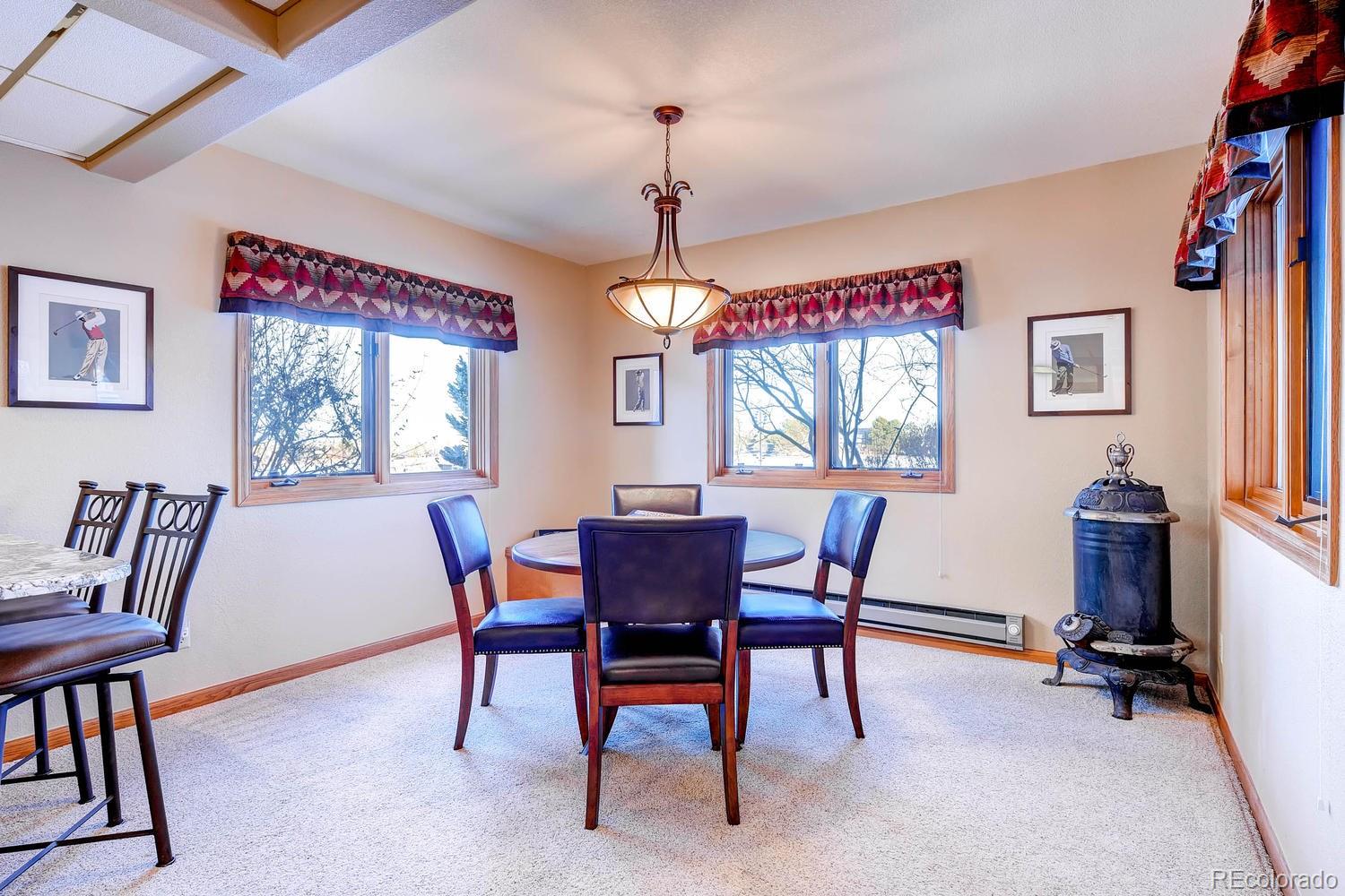 9470 Kemper Drive Lone Tree, CO 80124 - Photo 27 of 35 a dining room with furniture a chandelier and window