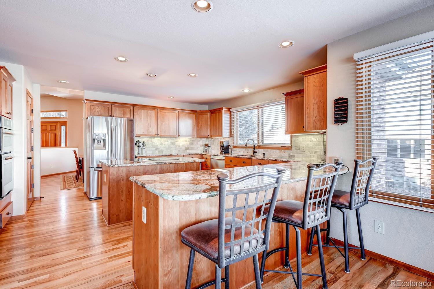 9470 Kemper Drive Lone Tree, CO 80124 - Photo 6 of 35 a view of a dining room with furniture and wooden floor