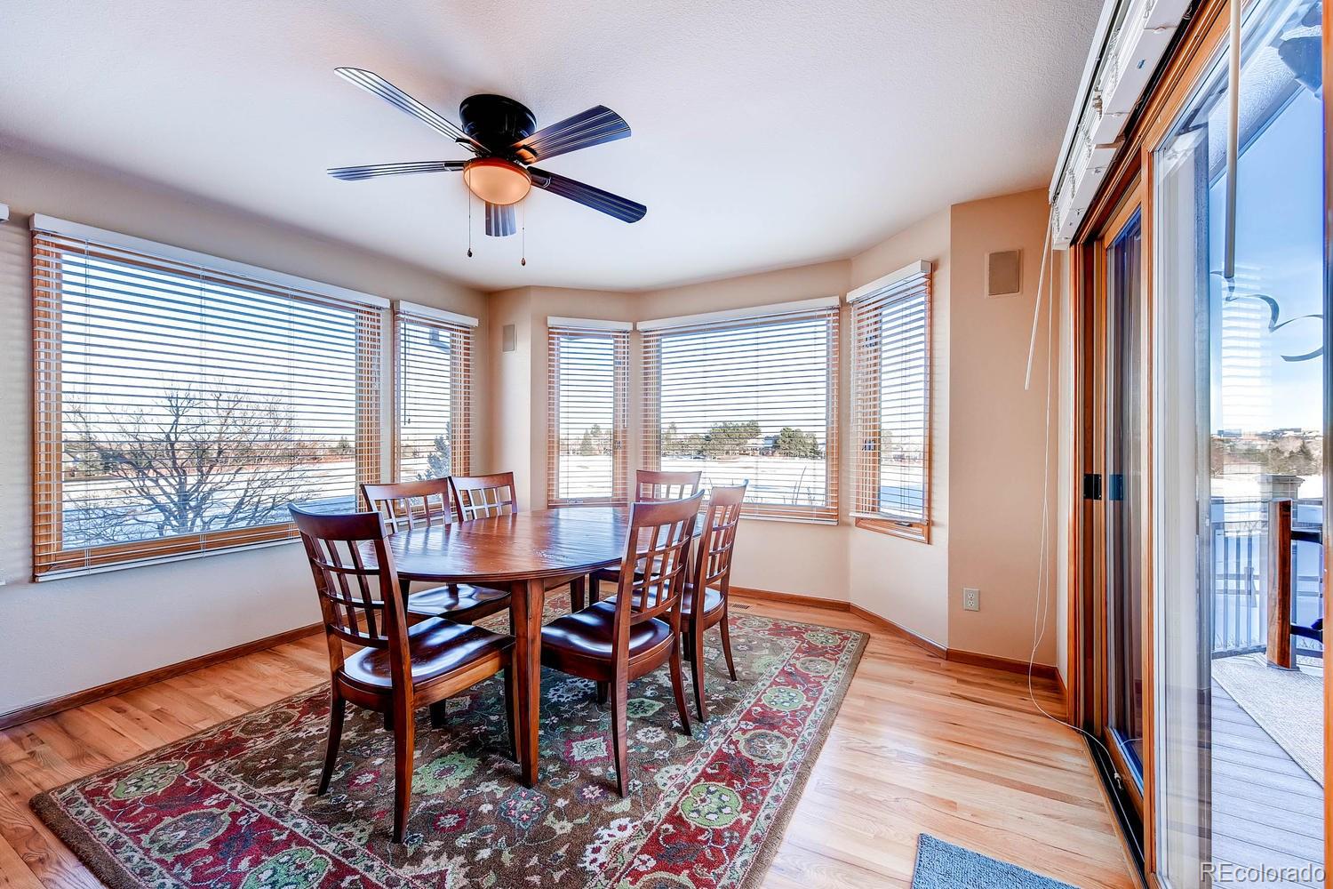 9470 Kemper Drive Lone Tree, CO 80124 - Photo 10 of 35 a view of a dining room with furniture window and wooden floor