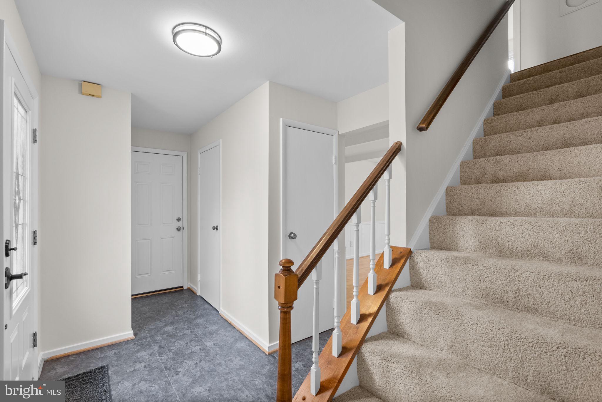 6170 Commodore Court Columbia, MD 21045 - Photo 19 of 49 a view of staircase with wooden floor and white walls