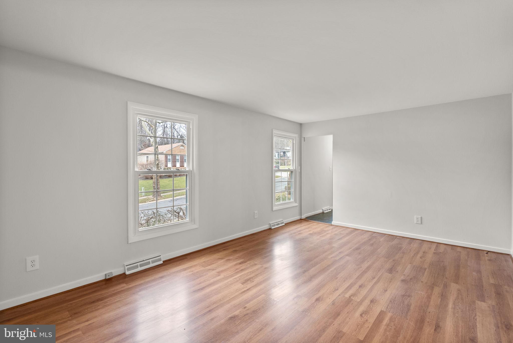 6170 Commodore Court Columbia, MD 21045 - Photo 2 of 49 an empty room with wooden floor and windows