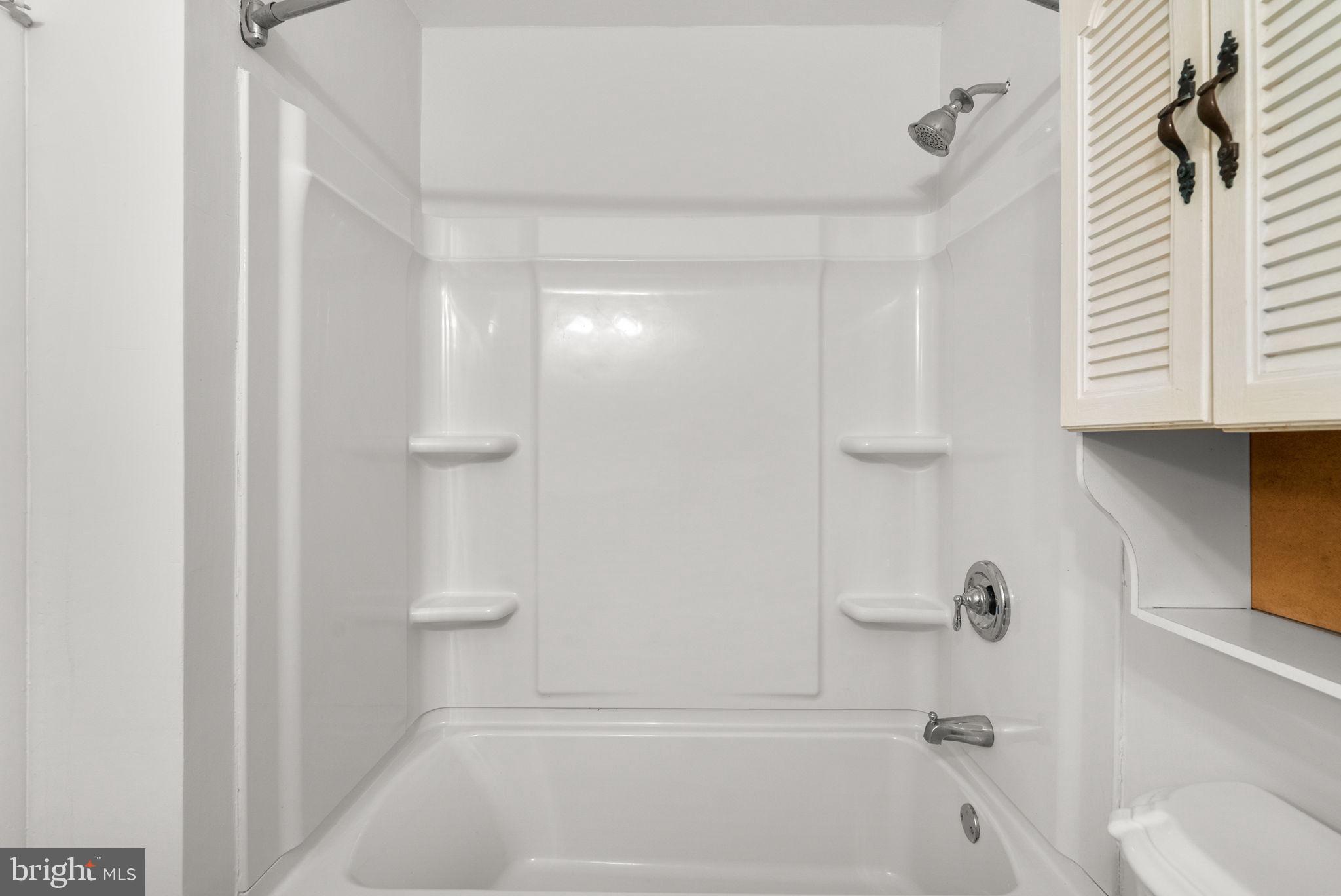 6170 Commodore Court Columbia, MD 21045 - Photo 31 of 49 a bathroom with a bathtub and a shower