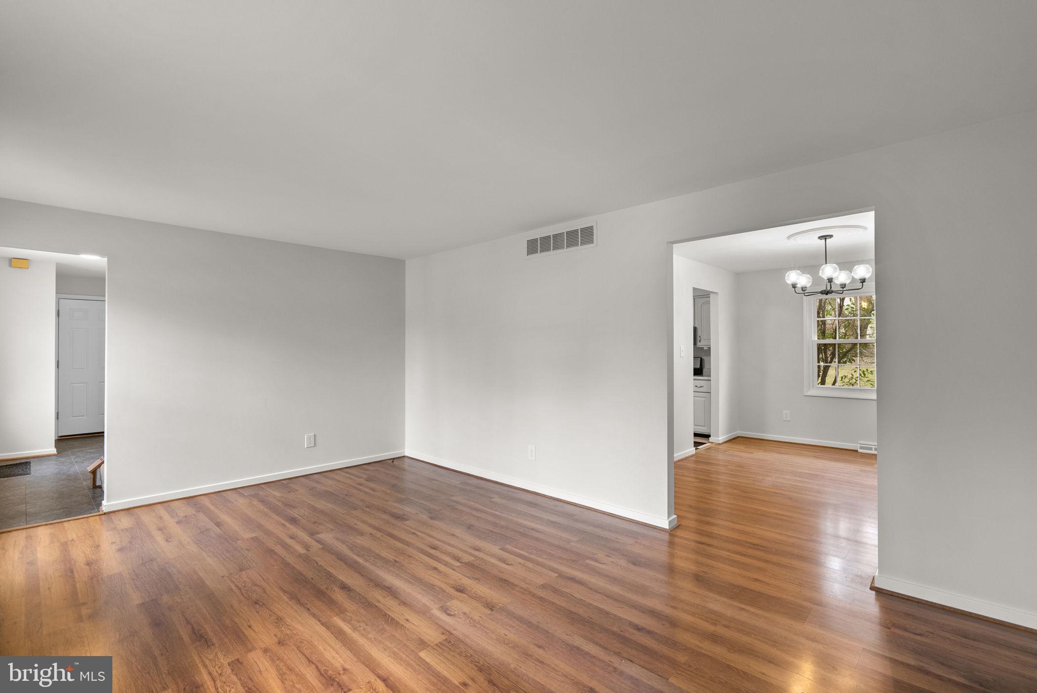 6170 Commodore Court Columbia, MD 21045 - Photo 4 of 49 a view of an empty room with wooden floor and a window