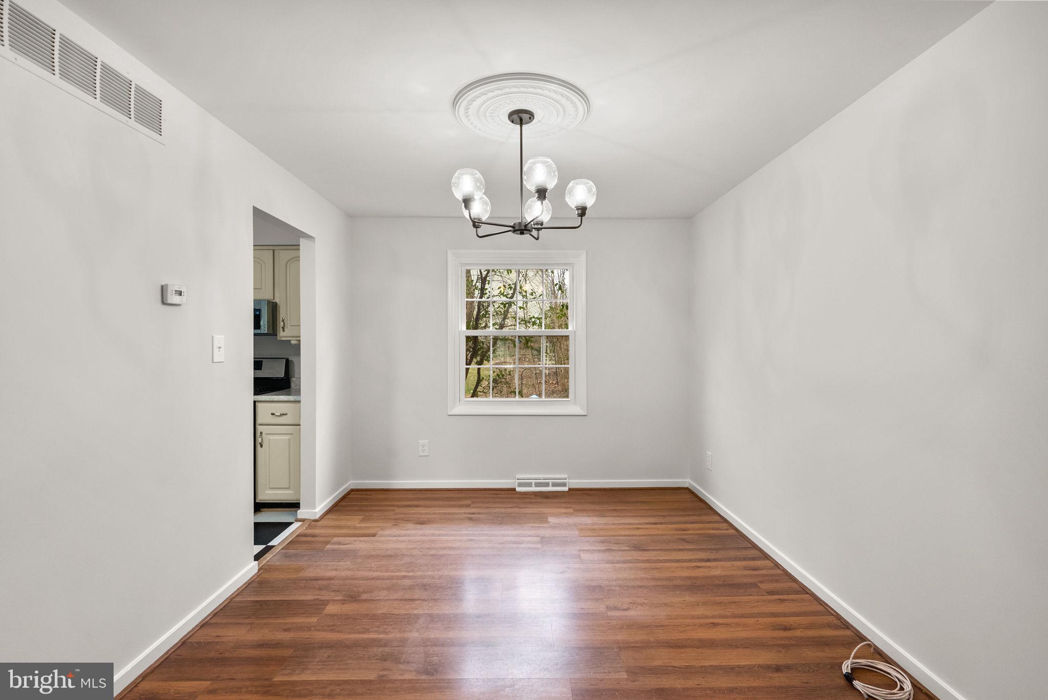 6170 Commodore Court Columbia, MD 21045 - Photo 5 of 49 a view of an empty room with wooden floor window and a bathroom