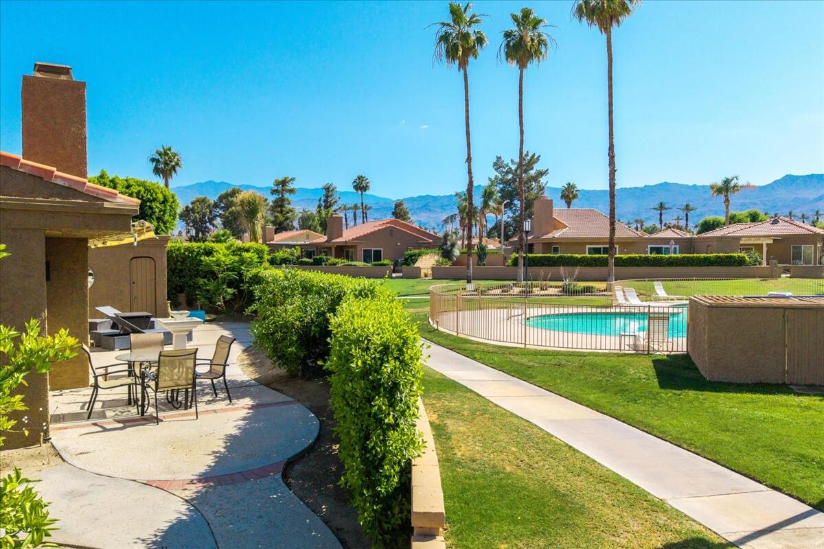 a view of a swimming pool with a lawn chairs