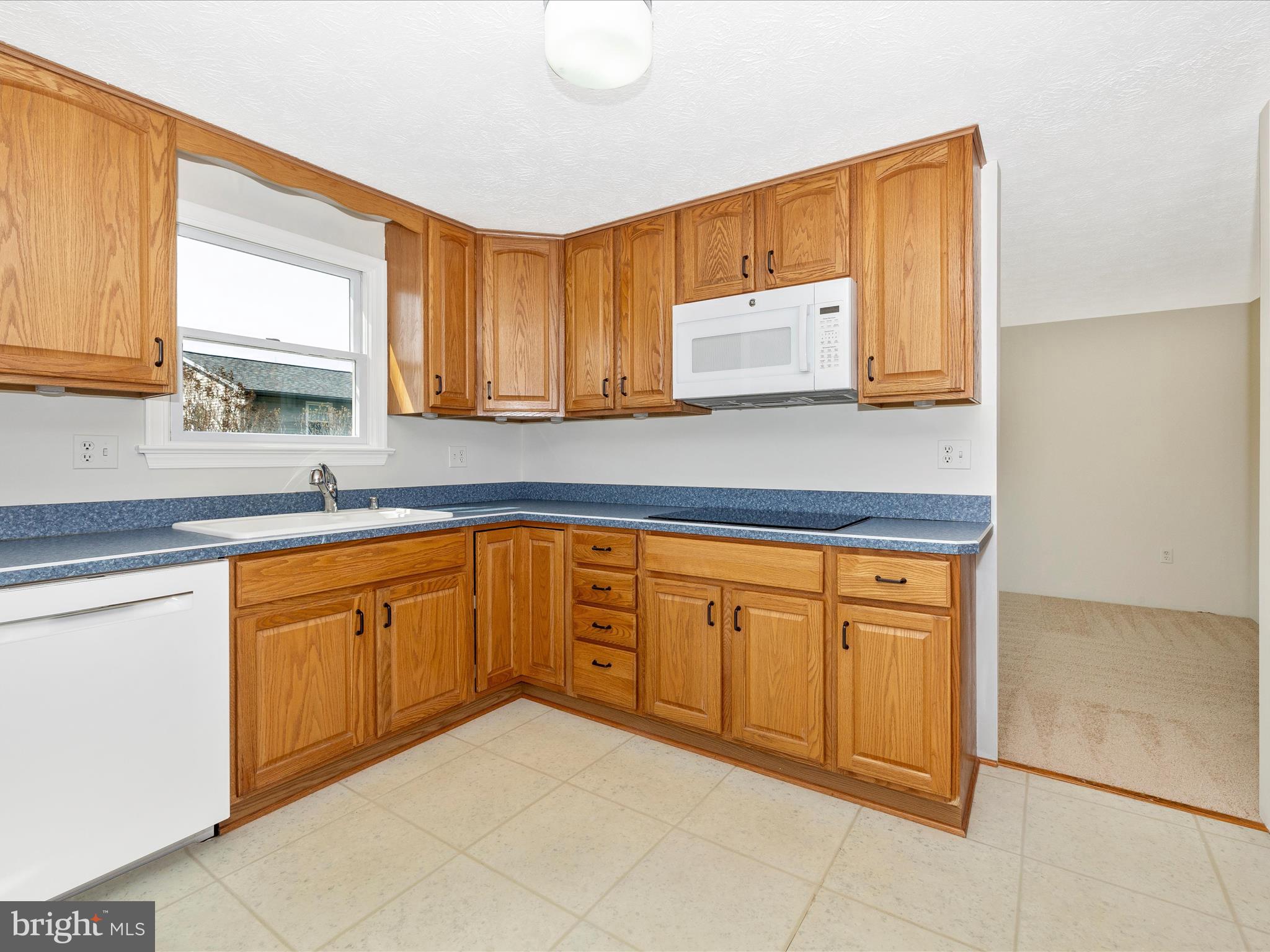 595 Old Stage Road Frederick, MD 21703 - Photo 12 of 43 a kitchen with stainless steel appliances granite countertop a sink and cabinets