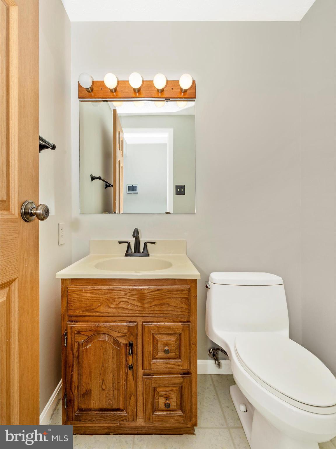 595 Old Stage Road Frederick, MD 21703 - Photo 21 of 43 a bathroom with a toilet a sink and mirror