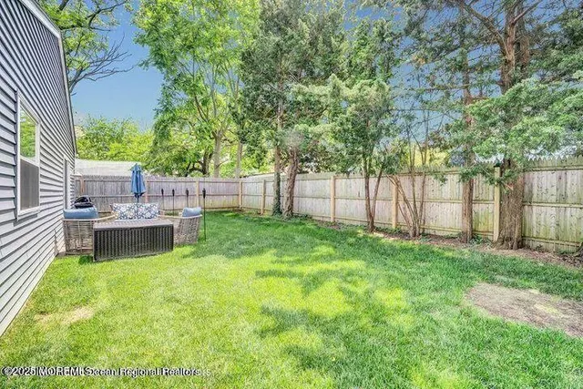 a view of a backyard with a garden and entertaining space