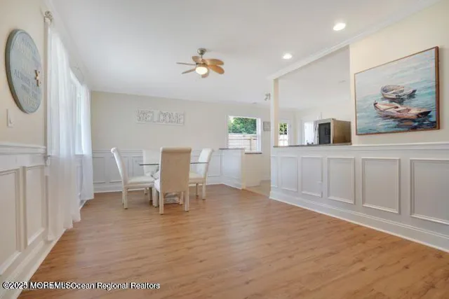 a view of a dining room with furniture window and wooden floor