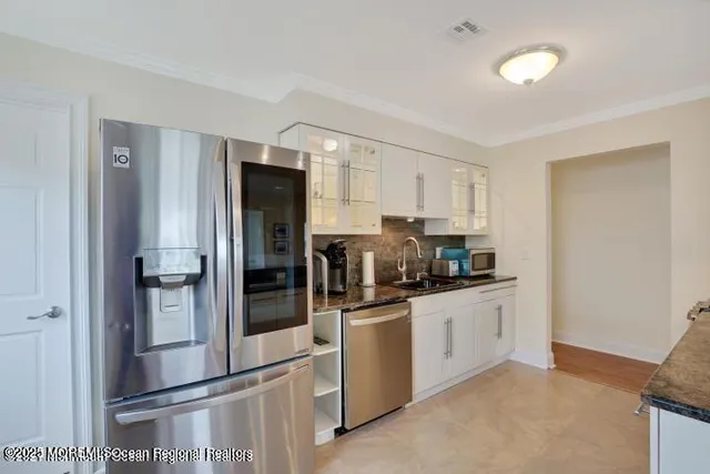 a kitchen with stainless steel appliances a refrigerator and a sink