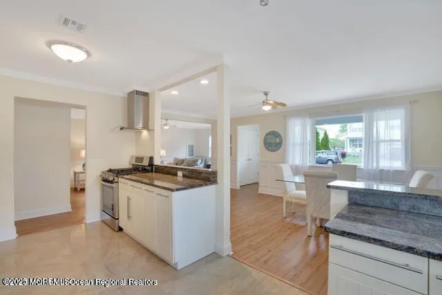a kitchen with stainless steel appliances granite countertop a stove and cabinets