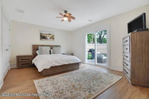 a bedroom with a large bed a chandelier and dresser