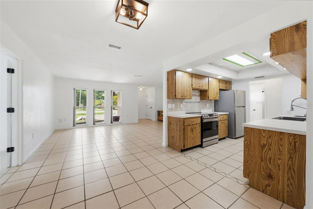 4536 Webber Street Sarasota, FL 34232 - Photo 9 of 45 a large kitchen with a stove a sink dishwasher and a refrigerator