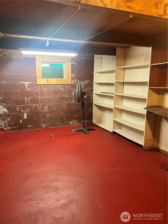 an empty room with a fireplace and room
