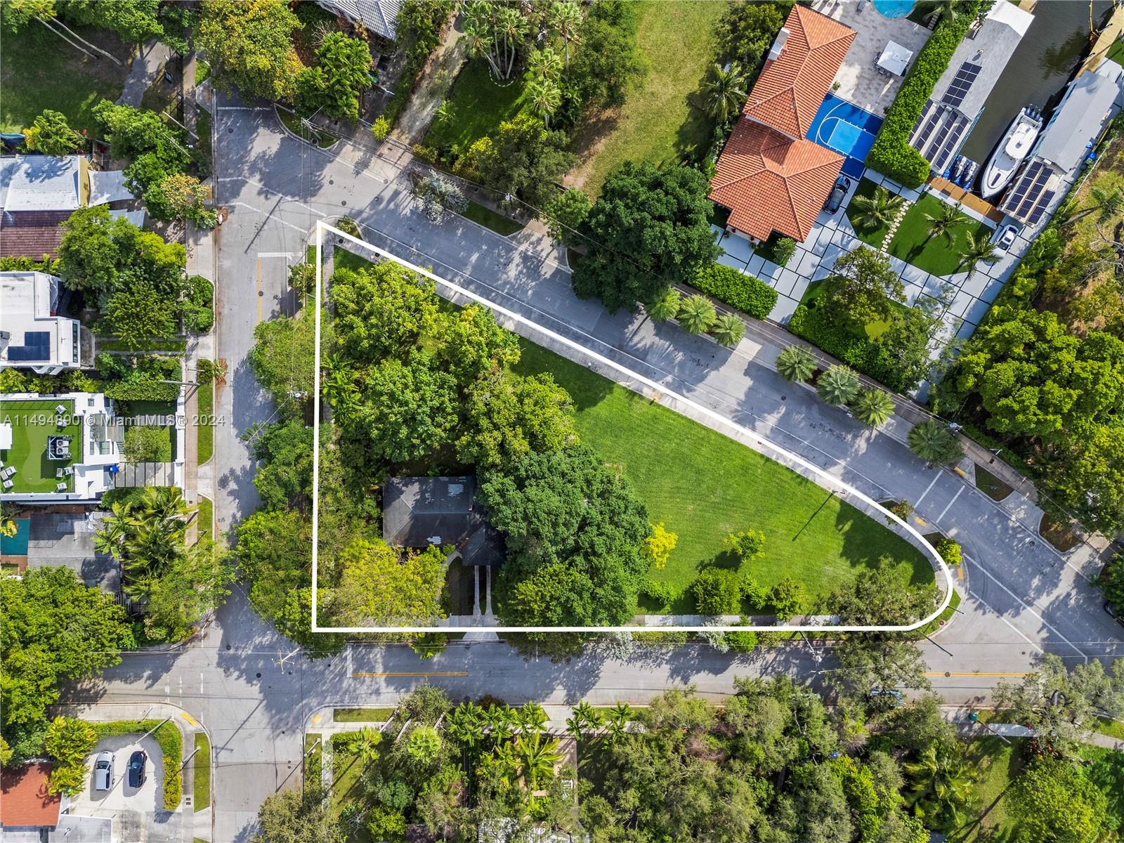 an aerial view of a house a yard and swimming pool