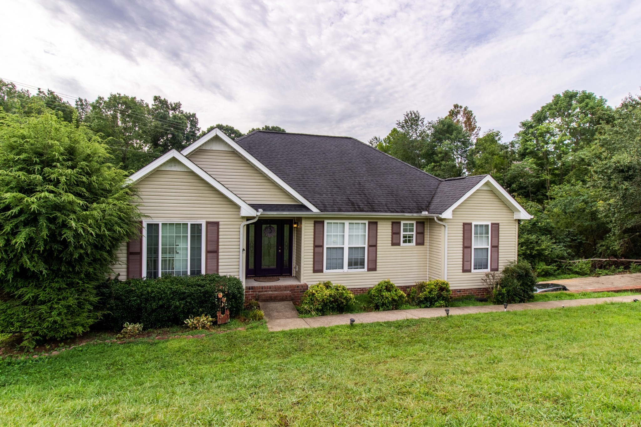a front view of a house with a yard and garage